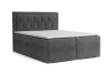 Graues Boxspringbett mit Knopfheftung auf weißem Hintergrund