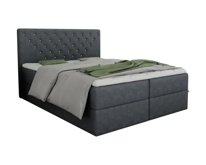 Dunkelgraues Boxspringbett mit gestepptem Kopfteil und grüner Bettwäsche.