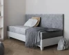 Elegant grey daybed with padded headboard and diamond pattern, ideal as a single bed.