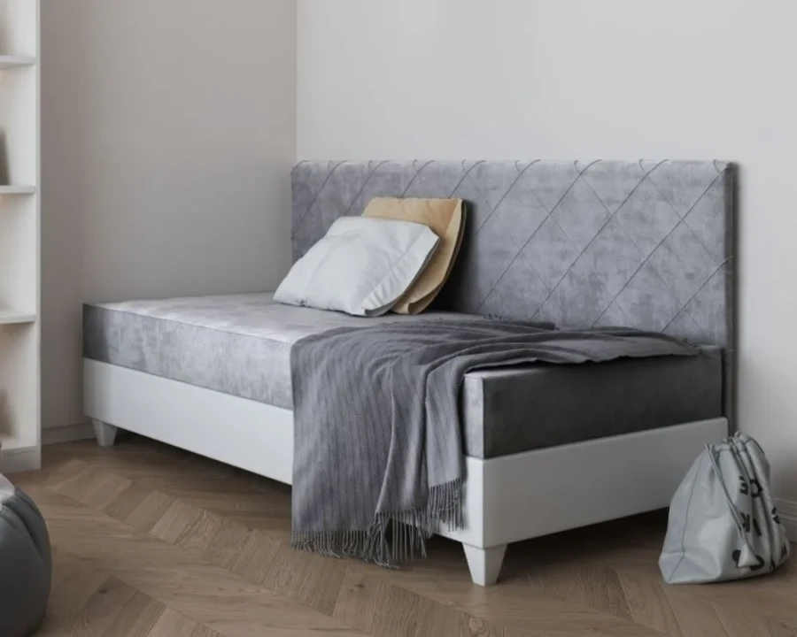 Elegant grey daybed with padded headboard and diamond pattern, ideal as a single bed.