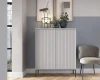 Graues Highboard mit Rillenstruktur und schwarzen Füßen vor einer zweifarbigen Wand.