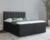 Komfortables Boxspringbett in Anthrazit mit gestepptem Kopfteil und grüner Dekoration.