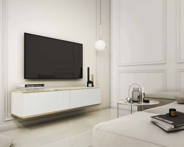 Weißes hängendes TV-Lowboard mit Goldrand in elegantem Wohnzimmer-Interieur.