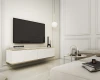 Weißes schwebendes TV-Board mit Goldleisten und geriffeltem Design im hellen Wohnzimmer.