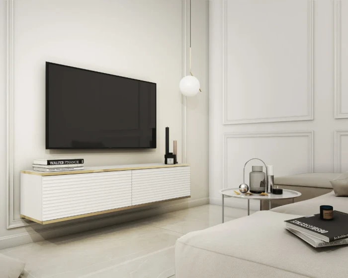 Weißes schwebendes TV-Board mit Goldleisten und geriffeltem Design im hellen Wohnzimmer.