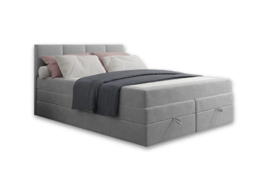 Hellgraues Boxspringbett mit Bettkasten, rosa-weißen Kissen und blauer Decke.