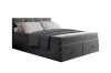 Dunkelgraues Boxspringbett mit Stauraum und gemütlicher Bettwäsche auf weißem Grund.