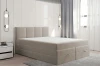 Beiges Boxspringbett ohne Bettzeug im modernen Schlafzimmer zeigt den praktischen Bettkasten.
