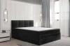 Graues Boxspringbett ohne Bettzeug zeigt den weißen Topper und Bettkasten.