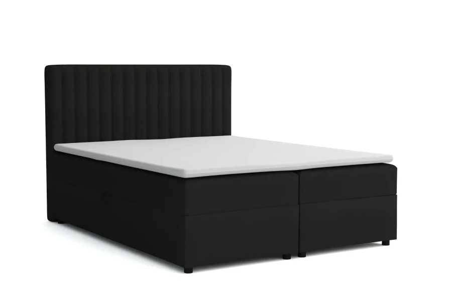 Schwarzes Boxspringbett mit vertikal gestepptem Kopfteil und Topper.
