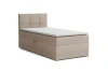 Beiges Boxspringbett mit Stoffbezug und hohem Kopfteil für das Schlafzimmer.
