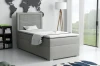 Graues Boxspringbett Einzelbett in modernem Schlafzimmer mit Weltkarte Wanddeko und Stehleuchte.