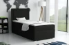 Modernes schwarzes Einzelbett im eingerichteten Schlafzimmer mit Wanddeko und Stehlampe.