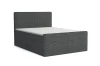 Dunkelgraues Boxspringbett mit strukturierter Oberfläche auf weißem Grund.
