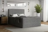 Graues Boxspringbett mit Cord-Struktur in gemütlicher Schlafzimmer-Atmosphäre.