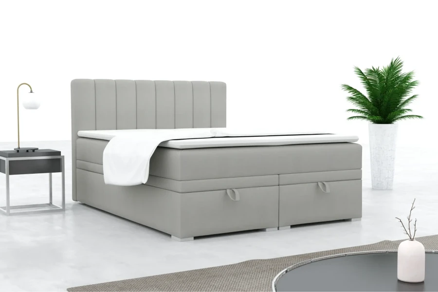 Modernes graues Boxspringbett mit gepolstertem Kopfteil in einem stilvollen Schlafzimmer.