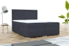 Anthrazitfarbenes Boxspringbett mit gepolstertem Kopfteil in modernem Schlafzimmer.