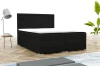 Schwarzes Boxspringbett mit markantem Kopfteil in einer stilvollen Schlafzimmerumgebung.