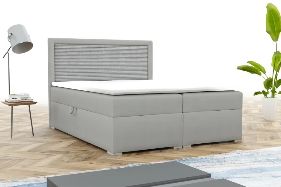 Modernes graues Boxspringbett mit stoffbezogenem Kopfteil in heller Schlafzimmerumgebung.