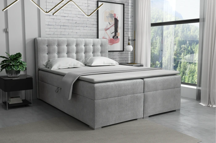 Elegantes Boxspringbett in Grau mit gepolstertem Kopfteil und Topper.