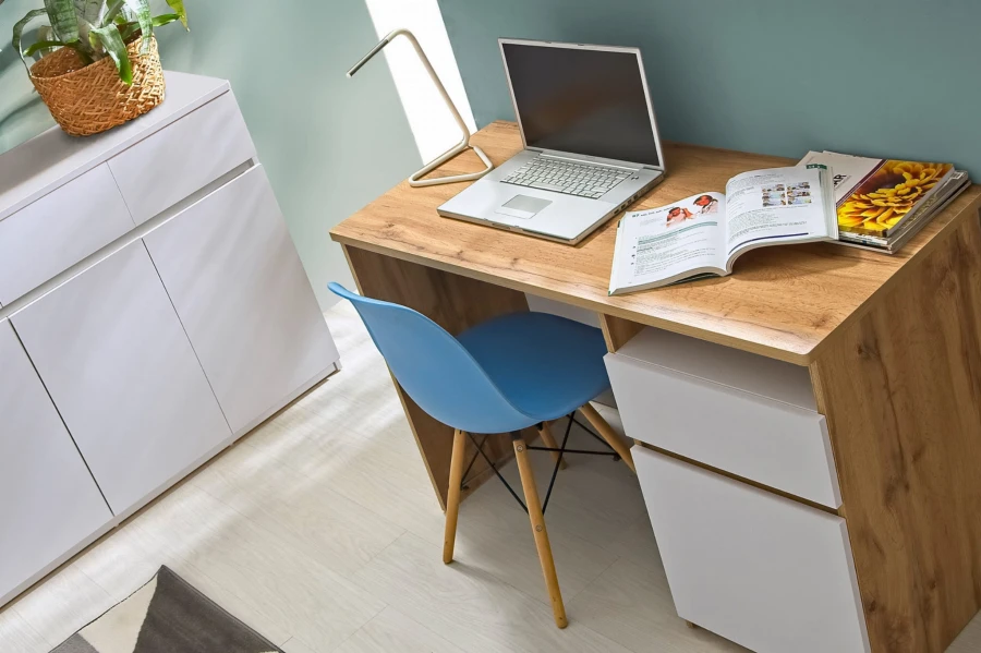 Detailansicht eines Schreibtischs in Eiche-Optik mit weißer Front und blauem Bürostuhl.