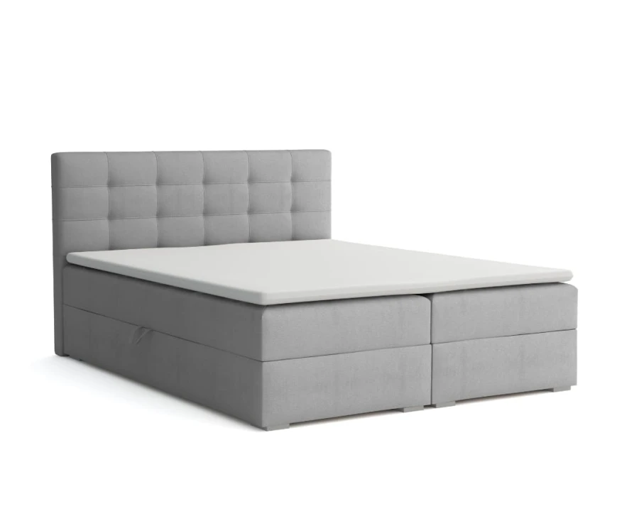 Graues Boxspringbett mit gestepptem Kopfteil und Stauraum, Ansicht von vorne links.