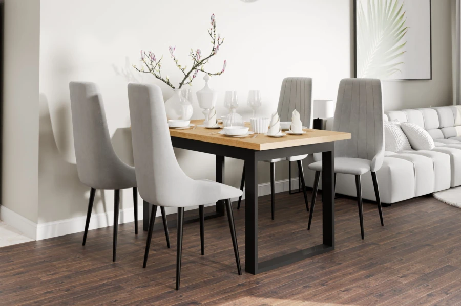 Modern dining table with light grey upholstered chairs in a bright living room setting.
