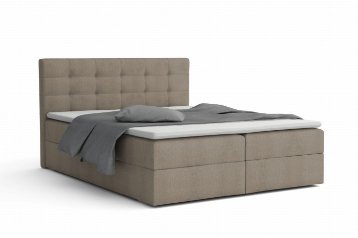 Beiges Boxspringbett mit gestepptem Kopfteil auf weißem Hintergrund.