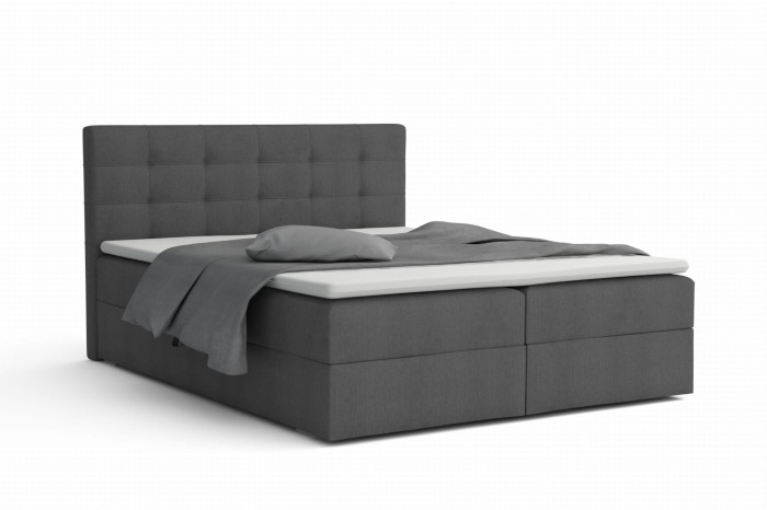 Modernes graues Boxspringbett mit gepolstertem Kopfteil vor weißem Hintergrund.