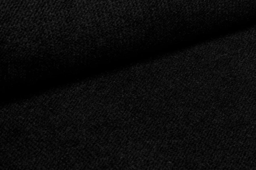 Detailed view of black textured fabric for upholstered furniture.
