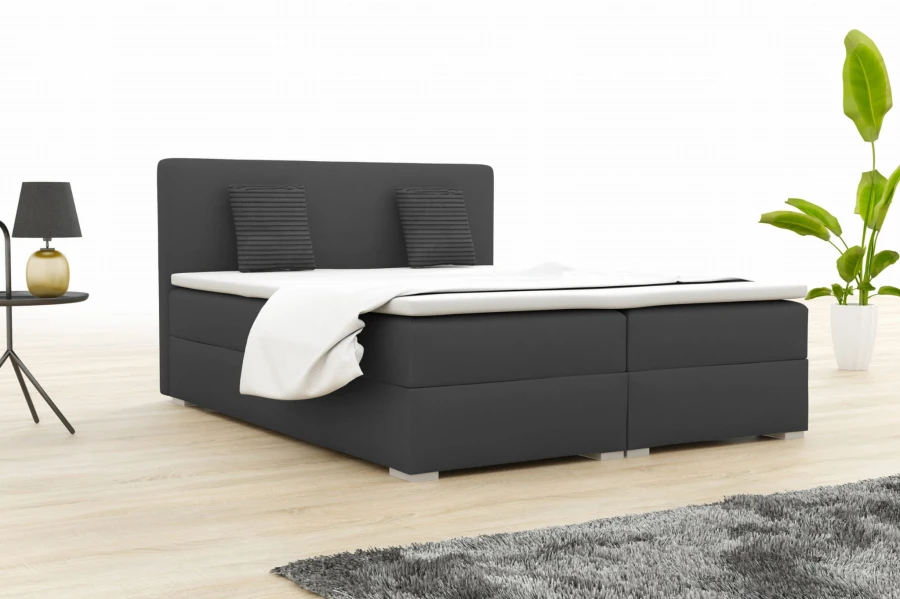 Antracietkleurig boxspringbed voor een tijdloos slaapkamerontwerp.