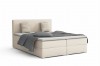 Crèmekleurig boxspringbed met grijze kussens en elegante look.