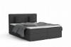 Anthrazitfarbenes Boxspringbett mit dunkelgrauem Stoffbezug und Kopfteil.