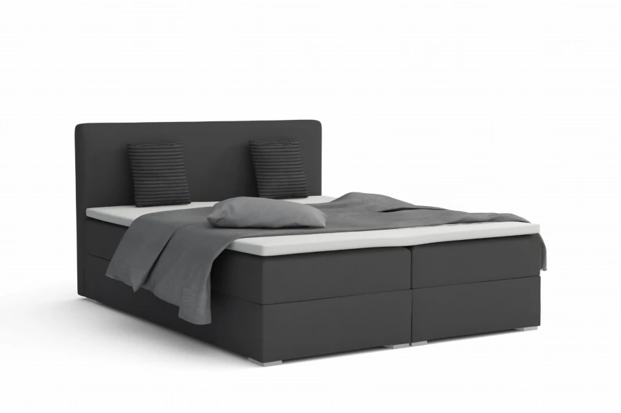 Anthrazitfarbenes Boxspringbett mit dunkelgrauem Stoffbezug und Kopfteil.
