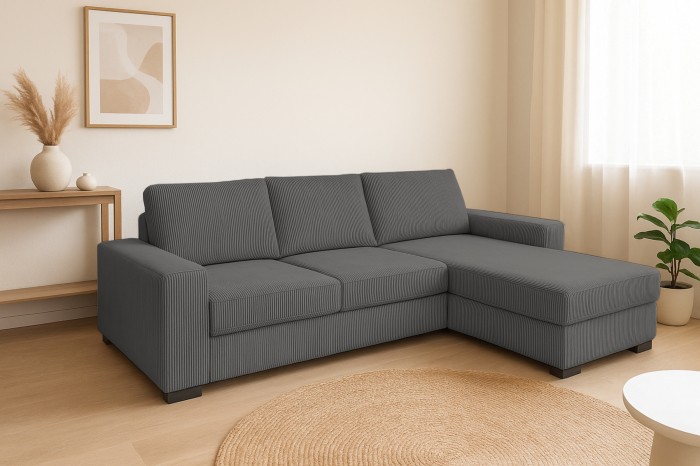 Modernes Ecksofa in Grau mit Cord-Struktur in einem hellen, minimalistischen Wohnzimmer.