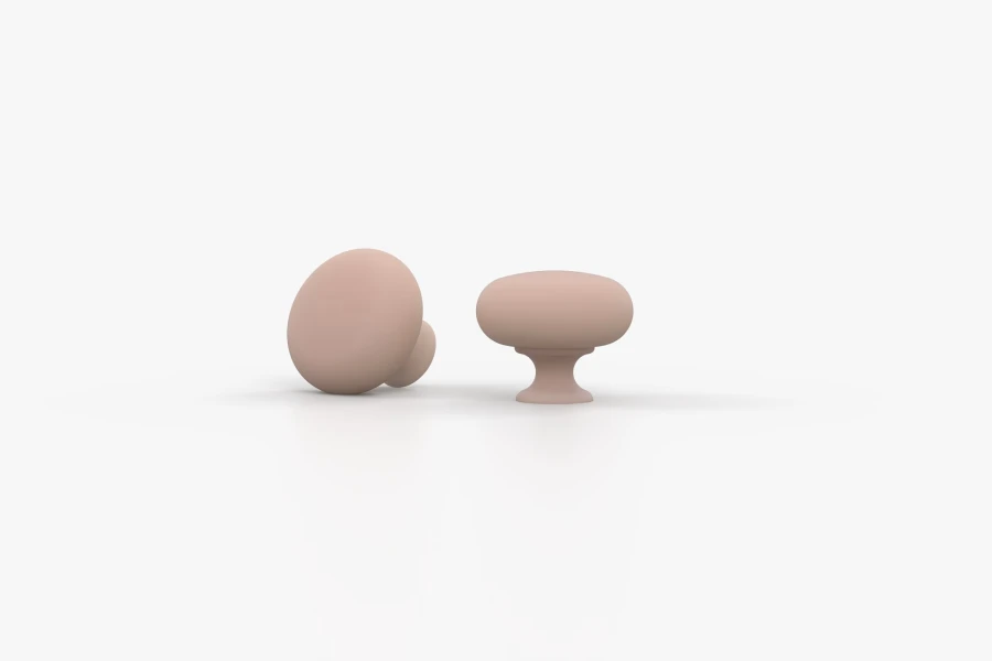 Zwei runde, matte Möbelknöpfe in Rosa als Zubehör für die Oskar Kollektion.