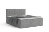 Grijs boxspringbed met corduroy bekleding en gecapitonneerd hoofdbord, modern slaapkamerontwerp.