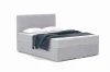 Graues Bouclé-Boxspringbett mit weißen Kissen und dunkelblauer Decke vor weißem Hintergrund.