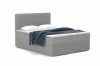 Modernes graues Boxspringbett mit Bouclé-Bezug, inklusive Kissen und Tagesdecke.