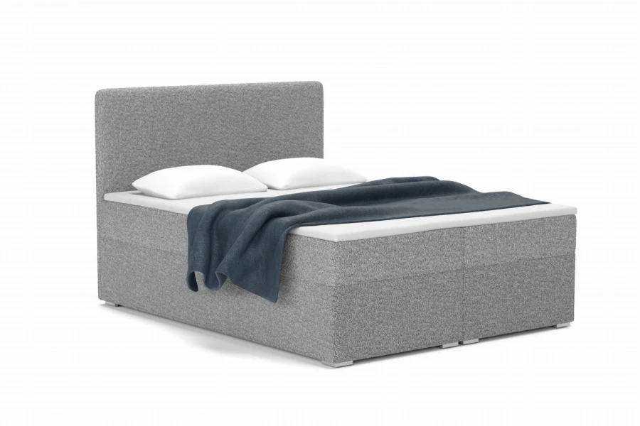Modernes graues Boxspringbett mit Bouclé-Bezug, inklusive Kissen und Tagesdecke.