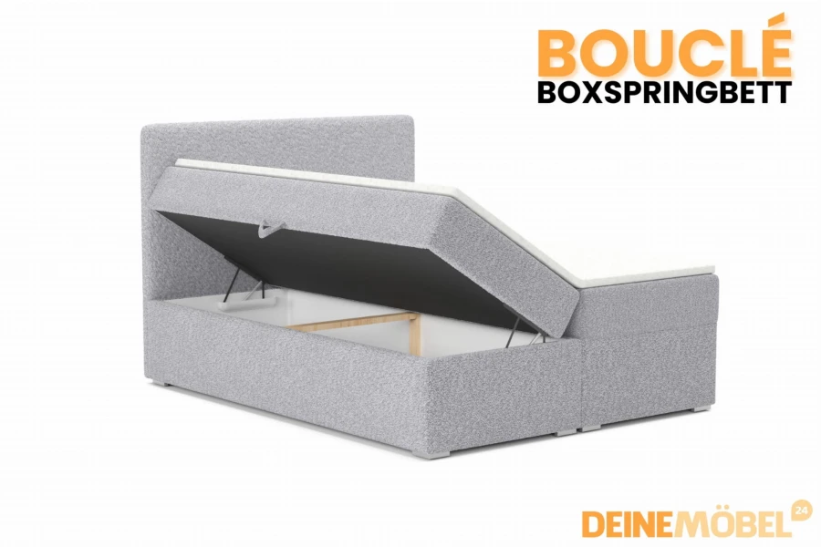 Graues Bouclé Boxspringbett mit offenem Bettkasten für zusätzlichen Stauraum im Schlafzimmer.