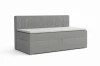 Modernes graues Boxspringbett mit vertikal gestreiftem Kopfteil und weißem Topper.