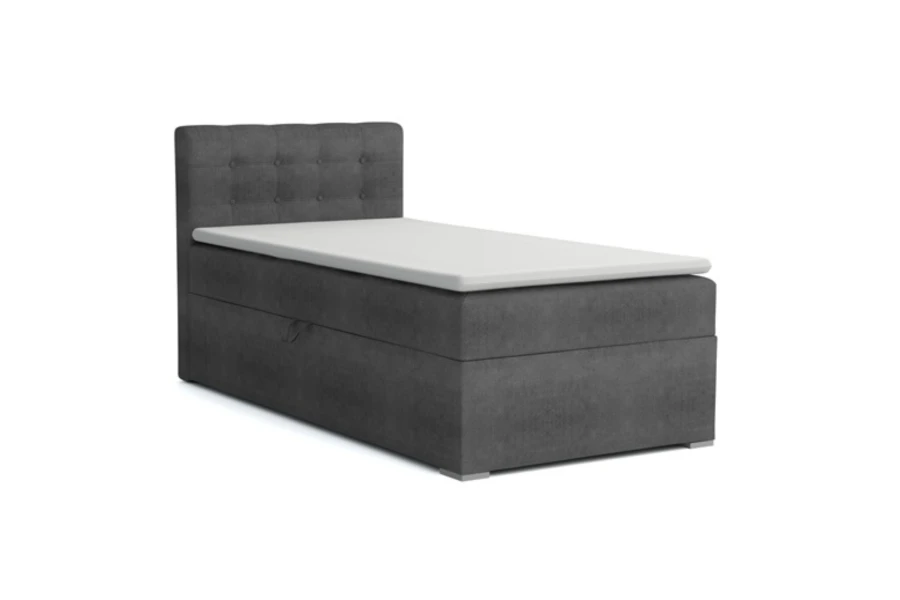 Graues Einzel-Boxspringbett mit gestepptem Kopfteil und weißem Topper auf weißem Hintergrund.