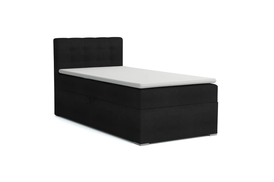 Schwarzes Boxspringbett JUNG III mit weißem Topper und gepolstertem Kopfteil, isoliert auf Weiß.