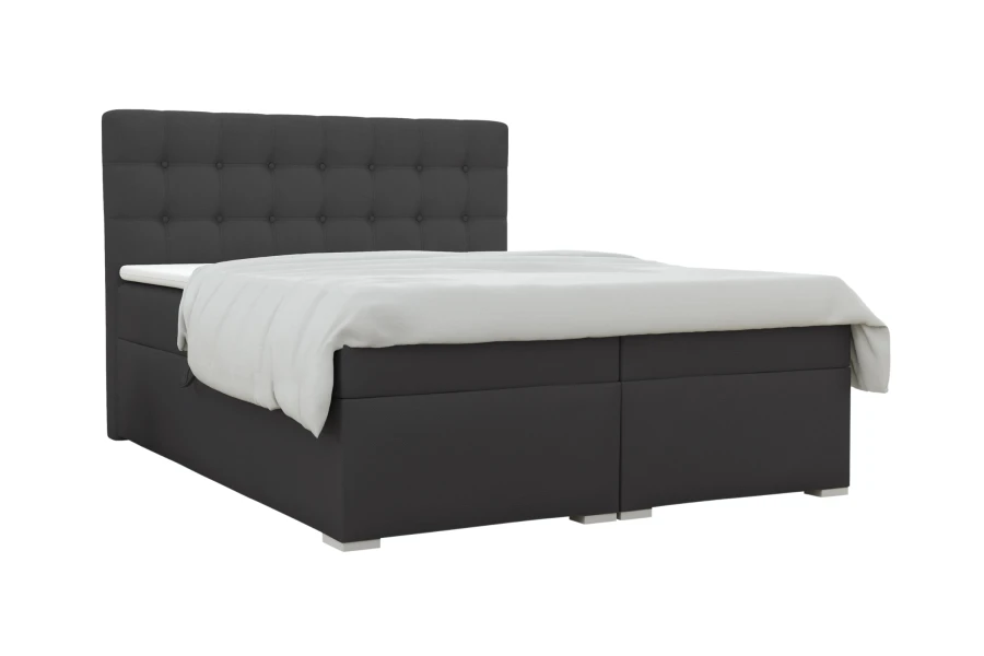 Dark grey boxspring bed with quilted headboard on white background