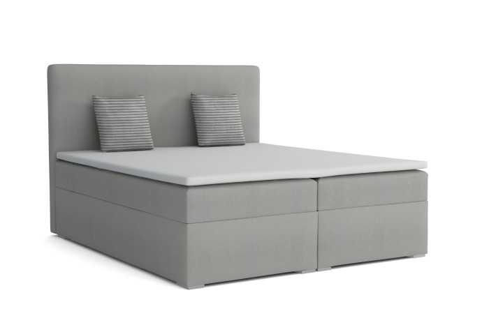 Grau gepolstertes Boxspringbett mit zwei Kissen und weißem Topper auf weißem Hintergrund.