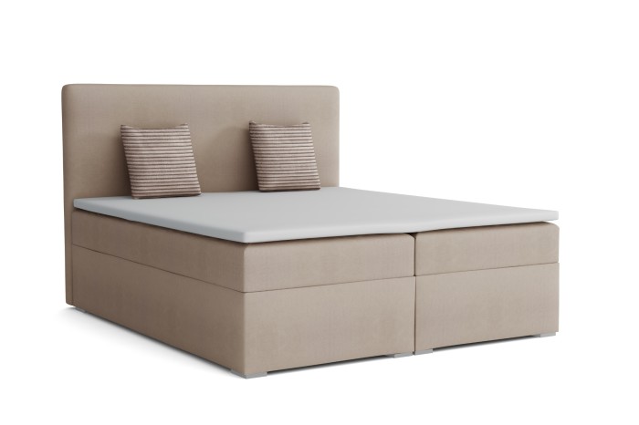 Beiges Boxspringbett inkl. Matratzen, Topper und Kissen vor weißem Hintergrund.