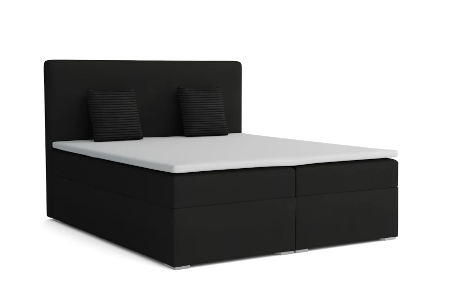 Schwarzes Boxspringbett mit Matratze, Topper und zwei passenden Kissen auf weißem Hintergrund freigestellt.