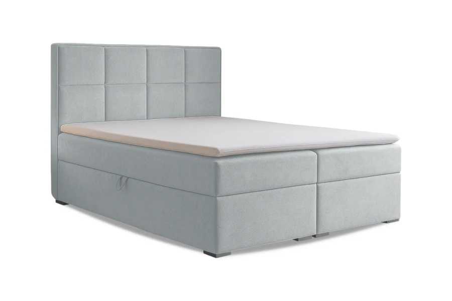 Modernes hellblaues Boxspringbett mit gestepptem Kopfteil auf weißem Hintergrund.