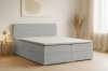 Modernes hellgraues Boxspringbett mit Cord-Bezug in hellem Schlafzimmer